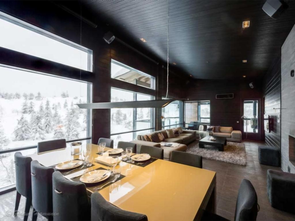 a dining room with a yellow table and chairs at Rukanhuippu in Ruka