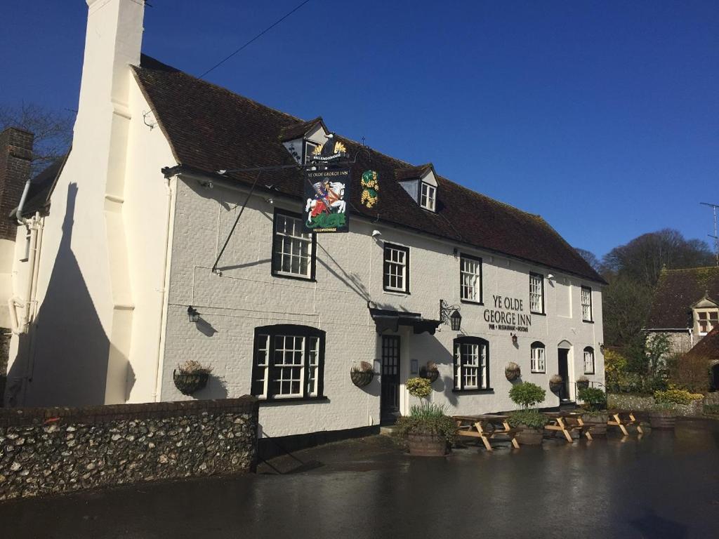 a white building with a black roof at Ye Olde George Inn - Badger Pubs in Privett