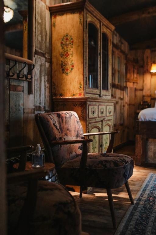 a living room with a chair and a table at The Joiners Arms in Chathill