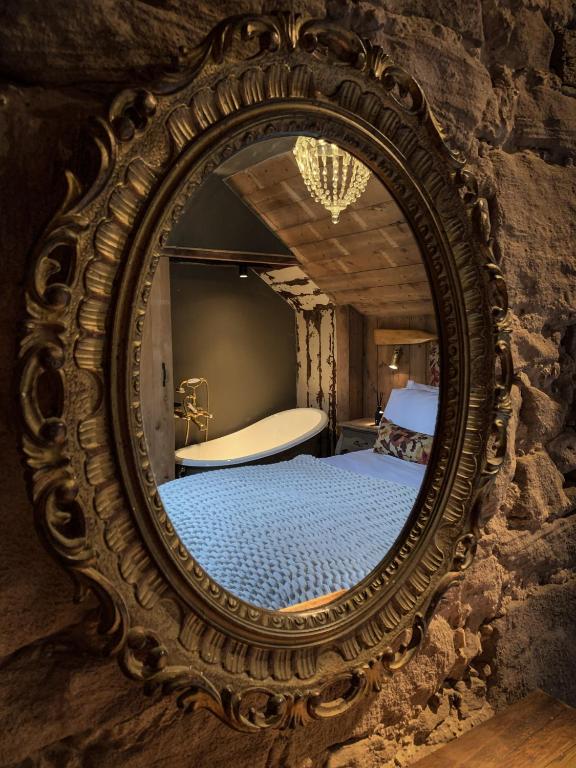 an antique mirror in a room with a bed at The Joiners Arms in Chathill