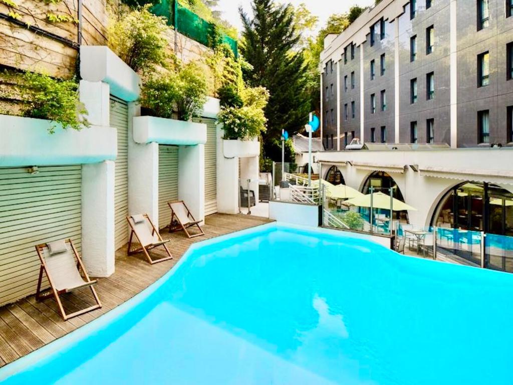 a large swimming pool on top of a building at Holiday Inn Lyon Vaise by IHG in Tassin-la-Demi-Lune