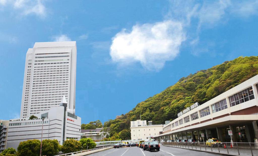 a city street with buildings and a mountain at ANA Crowne Plaza Kobe, an IHG Hotel in Kobe