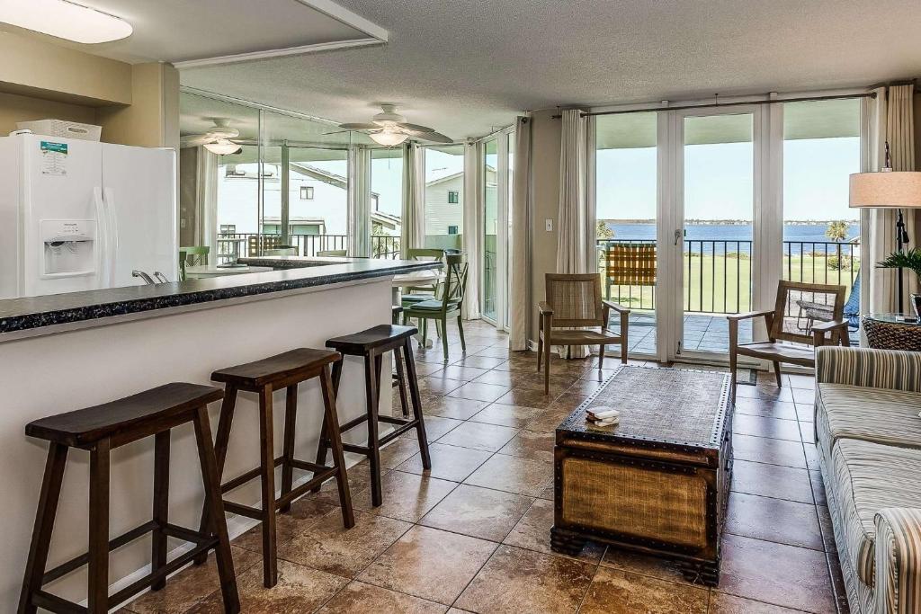a living room with a bar with stools at Santa Rosa Dunes 923 in Pensacola Beach