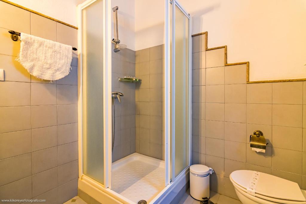 a bathroom with a shower and a toilet at Cortijo El Indiviso in Vejer de la Frontera