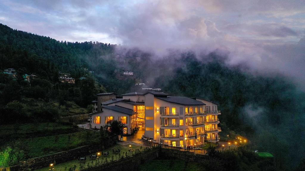 a large building in the middle of a mountain at Welcomhotel by ITC Hotels, Shimla in Shimla