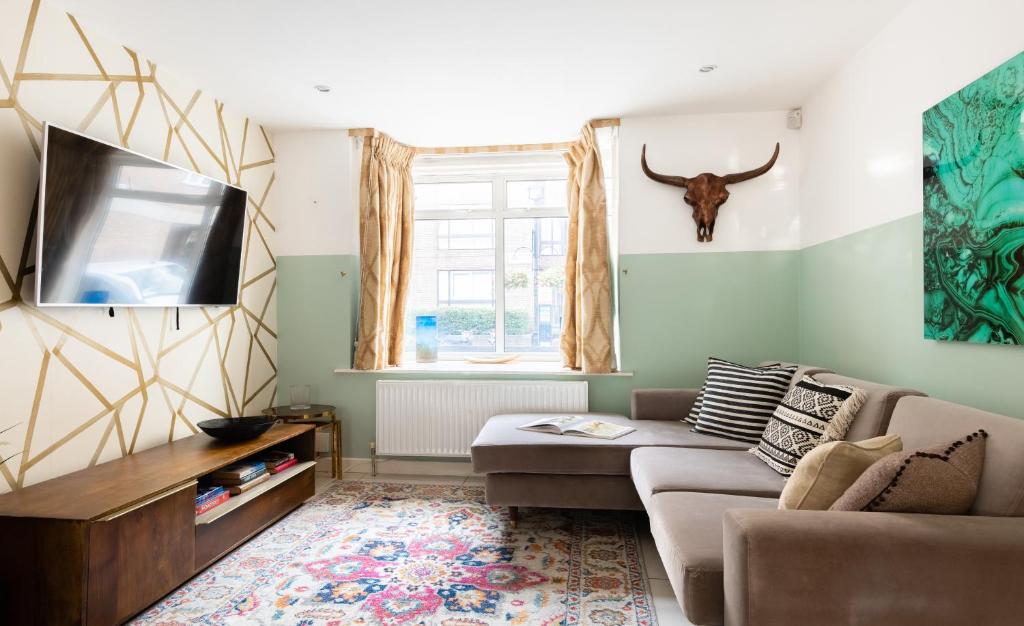 a living room with a couch and a flat screen tv at The Southwick Sanctuary - Large 6BDR with Terrace in London