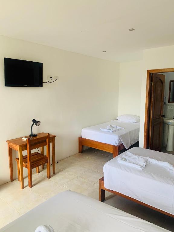 Postel nebo postele na pokoji v ubytování Hostal White House Galapagos