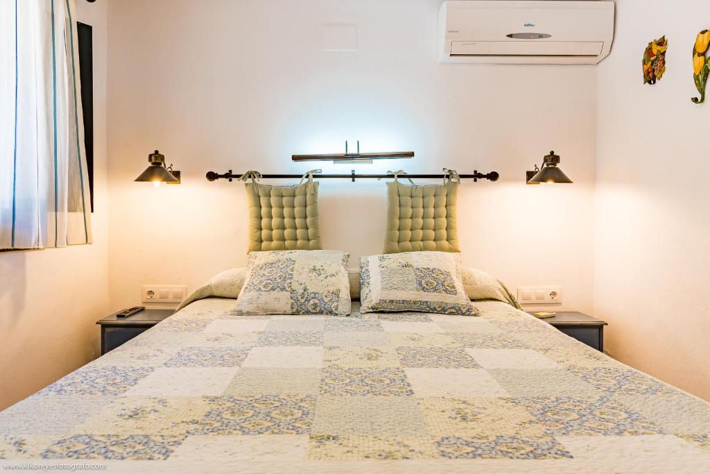 a bedroom with a large bed with two night stands at Cortijo El Indiviso in Vejer de la Frontera