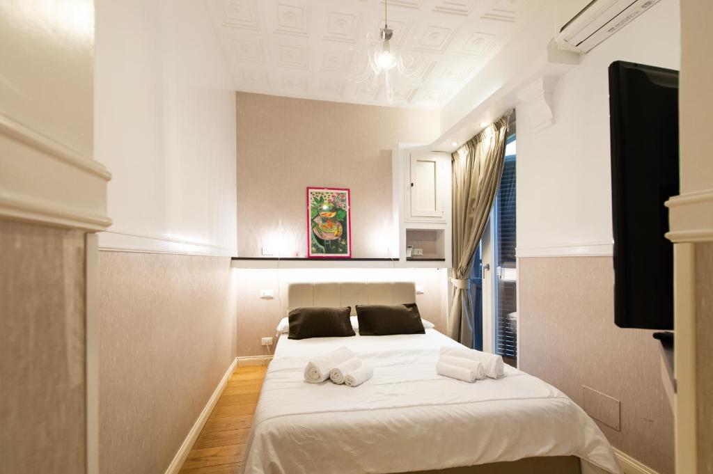 a bedroom with a bed with towels on it at Magenta Collection Sant'Anna in Rome