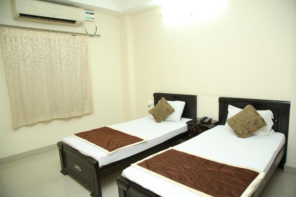 a room with two beds in a room at Skyview Suites in Hyderabad