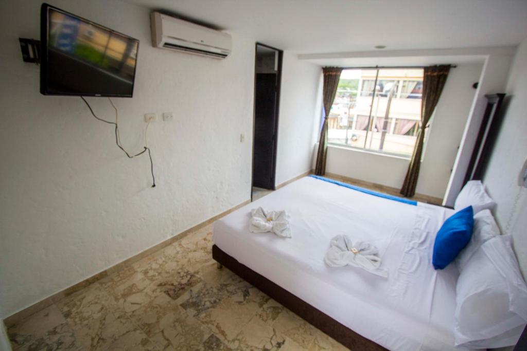 Postel nebo postele na pokoji v ubytování Blue Star Hotel