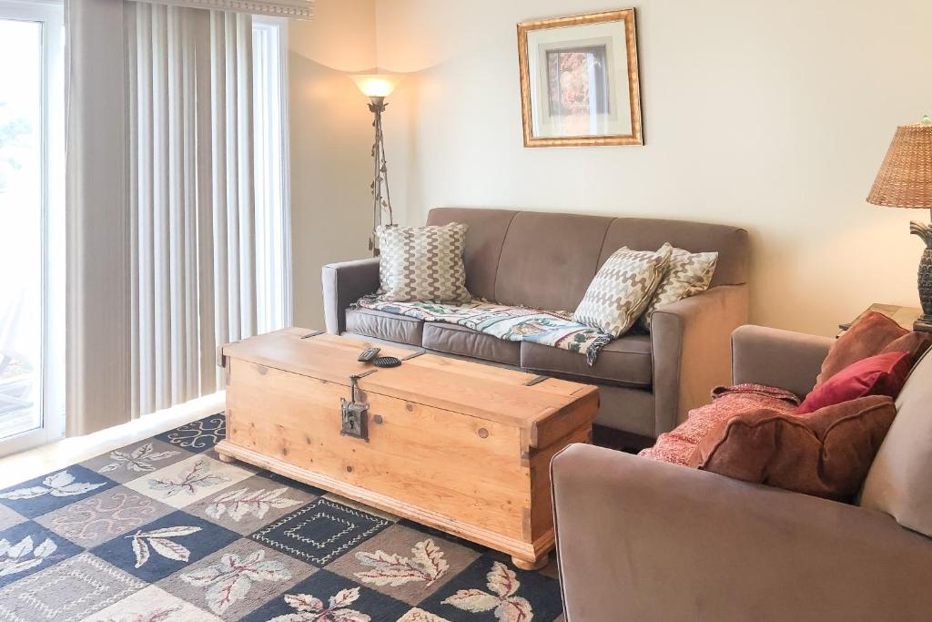 a living room with a couch and a coffee table at Mountainside Resort K204 in Stowe