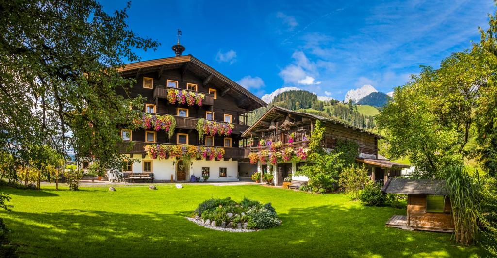 a building with a green lawn in front of it at Matzhof in Leogang