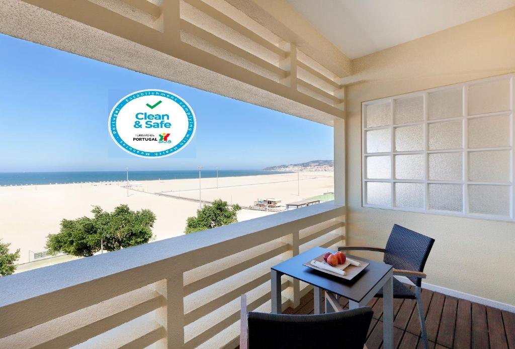 
a dining room table with a view of the ocean at Hotel Mercure Figueira Da Foz in Figueira da Foz
