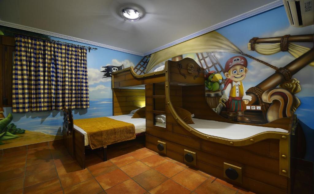 une chambre pour enfants avec une fresque murale représentant un bateau pirate dans l'établissement El Volante, à Ciempozuelos