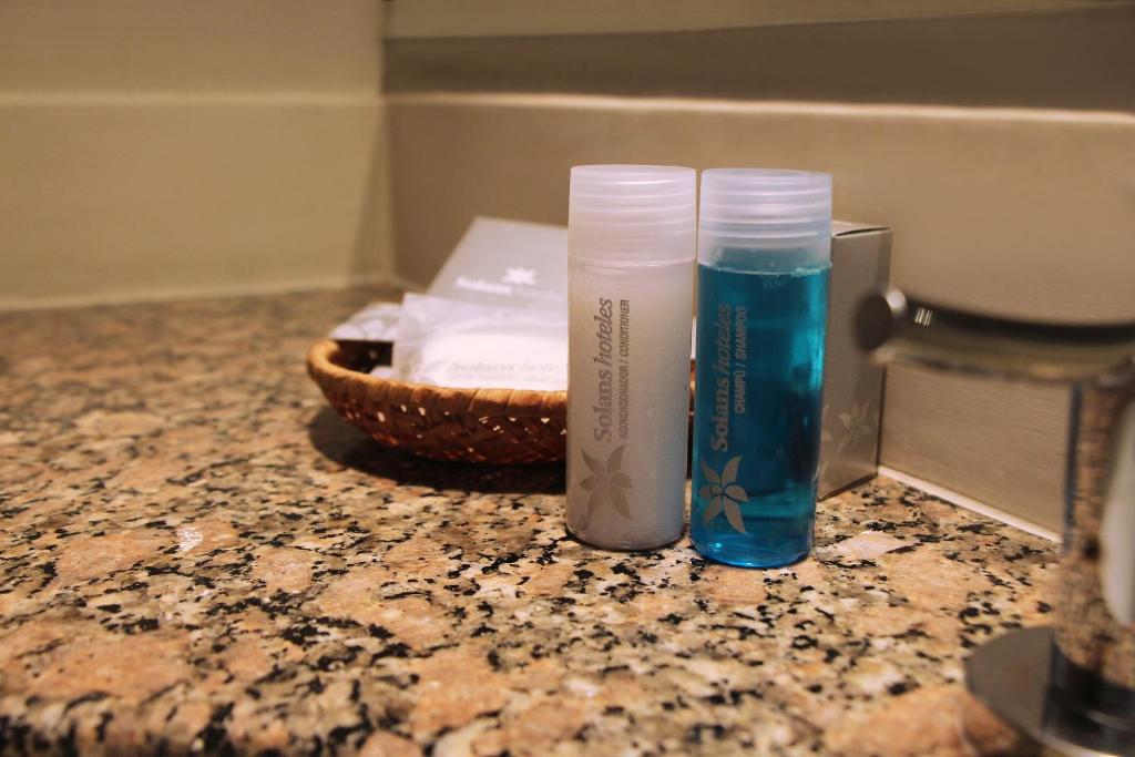 two toothbrushes sitting on top of a counter top at Hotel Solans Riviera in Rosario
