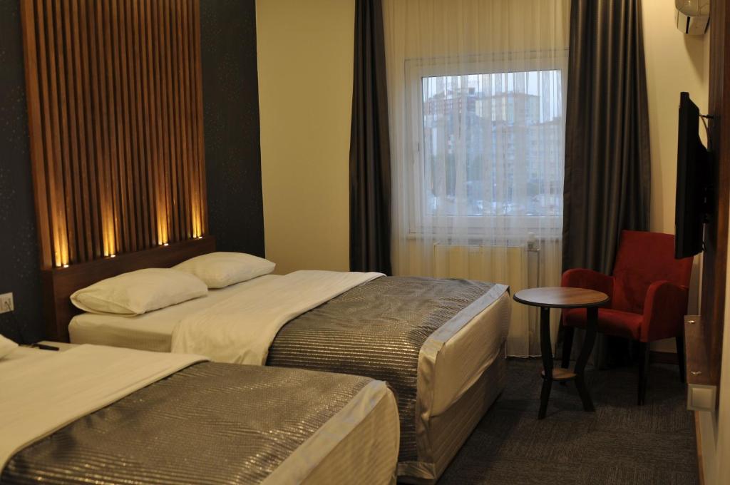 a hotel room with two beds and a window at ADMİRAL in Kayseri