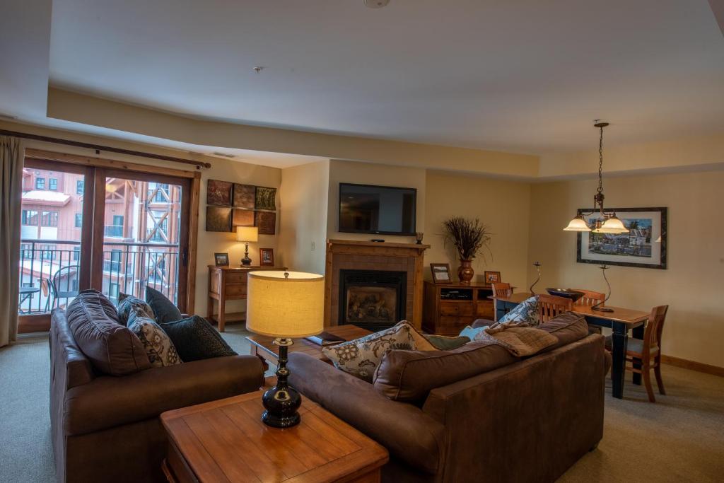 a living room with two couches and a table at Comfortable 1 Bedroom Condo - Slopeside condo in Crested Butte