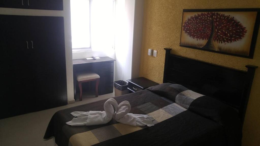 Postel nebo postele na pokoji v ubytování Hotel San Miguel