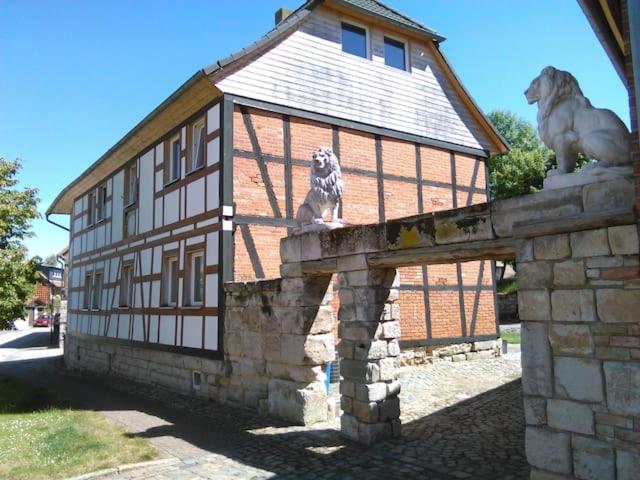 a dog sitting on top of a building at Mario's fachwerkhaus am Huy in Schlanstedt