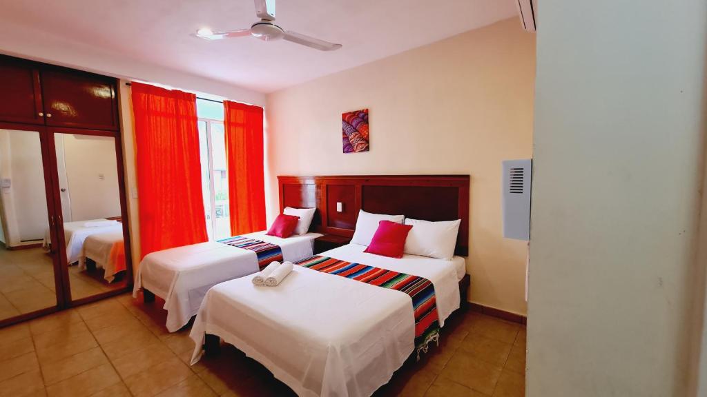 Postel nebo postele na pokoji v ubytování Hotel Machos Mahahual