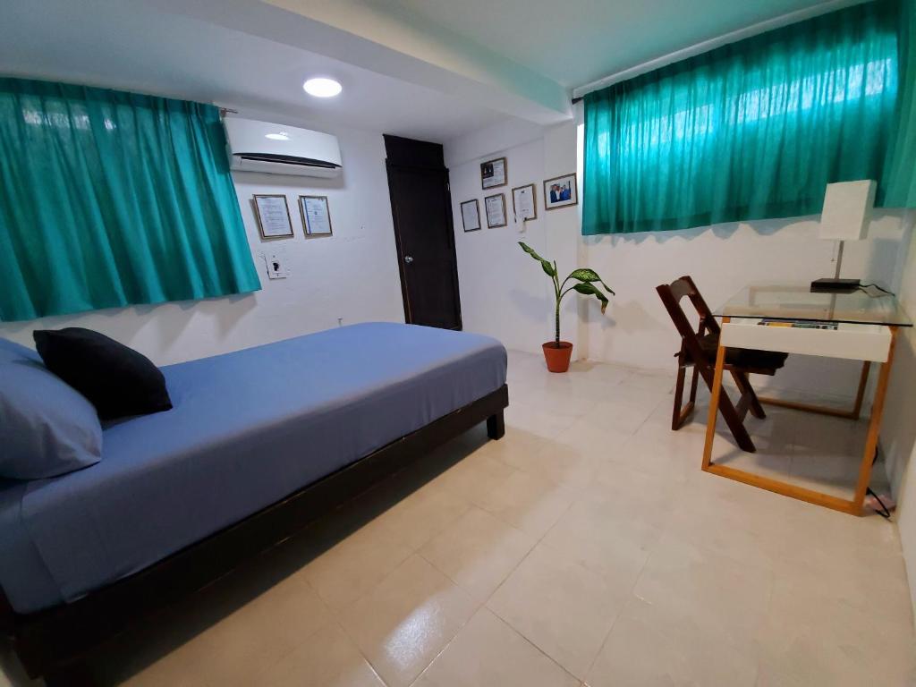 Postel nebo postele na pokoji v ubytování Downtown Hostel Chetumal