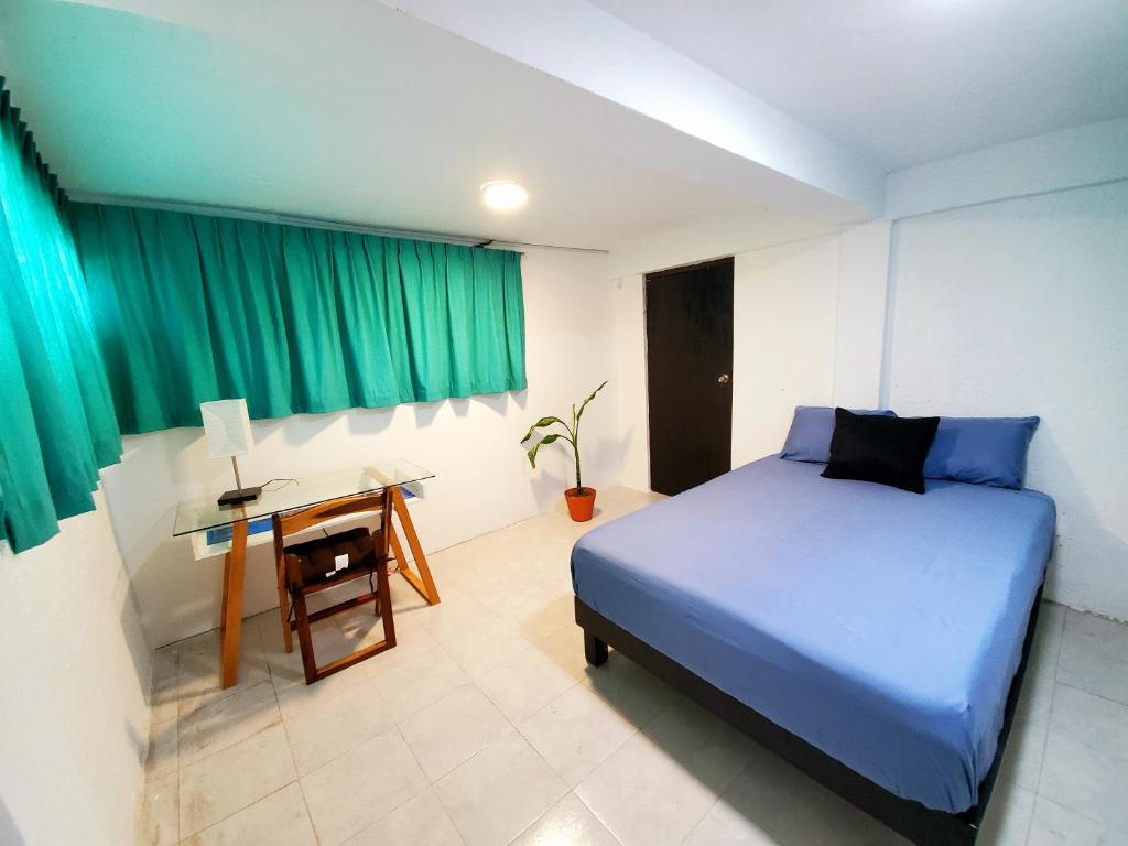 Postel nebo postele na pokoji v ubytování Downtown Hostel Chetumal
