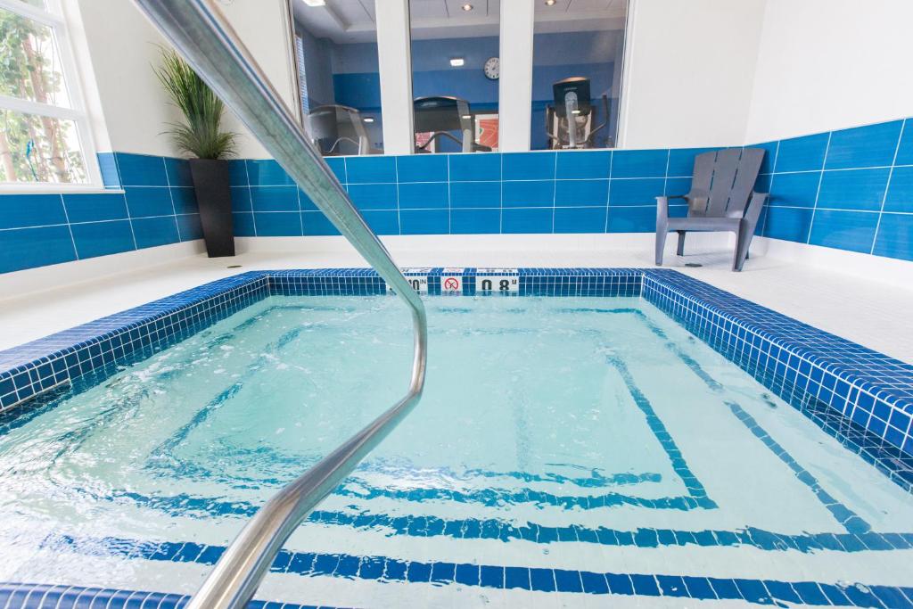 a swimming pool with a water hose at Holiday Inn Express & Suites Spruce Grove - Stony Plain by IHG in Spruce Grove