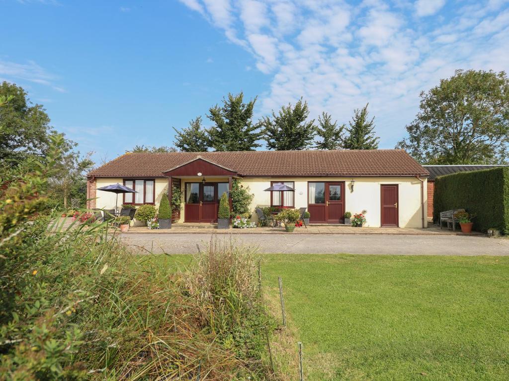 a house with a lawn in front of it at Willow Barn in Wincanton