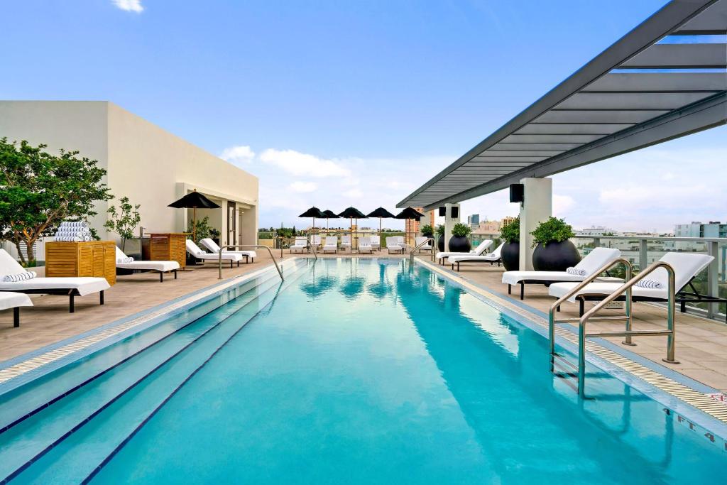 a swimming pool on the roof of a building at Kimpton Angler’s Hotel South Beach, an IHG Hotel in Miami Beach