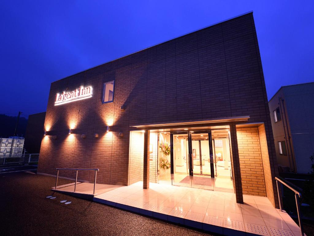 a building with a sign on the side of it at La'gent Inn Kesennuma in Kesennuma