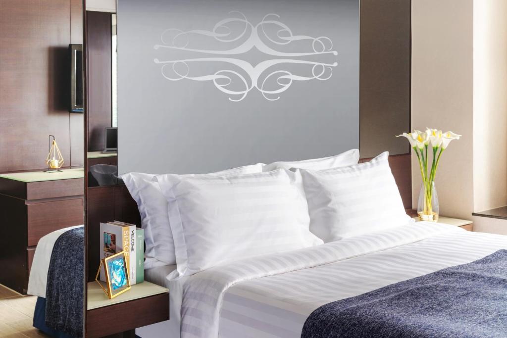 Letto o letti in una camera di Harbour Plaza 8 Degrees