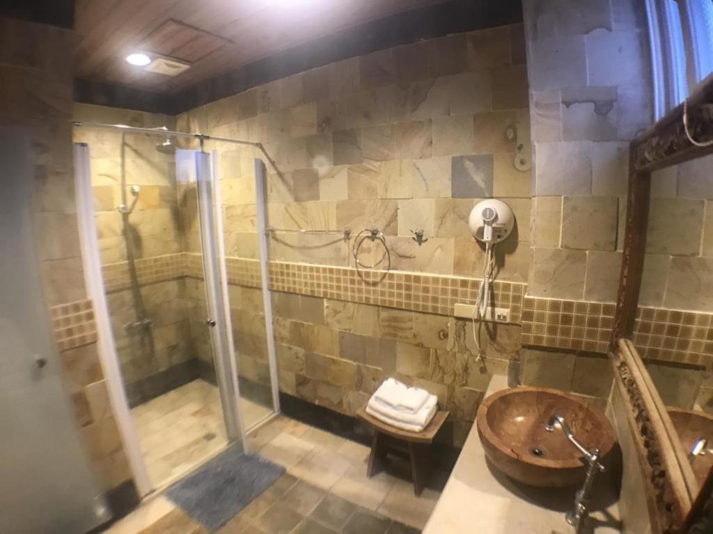 a bathroom with a shower and a wooden sink at Golden Ocean Azure Hotel in Kenting
