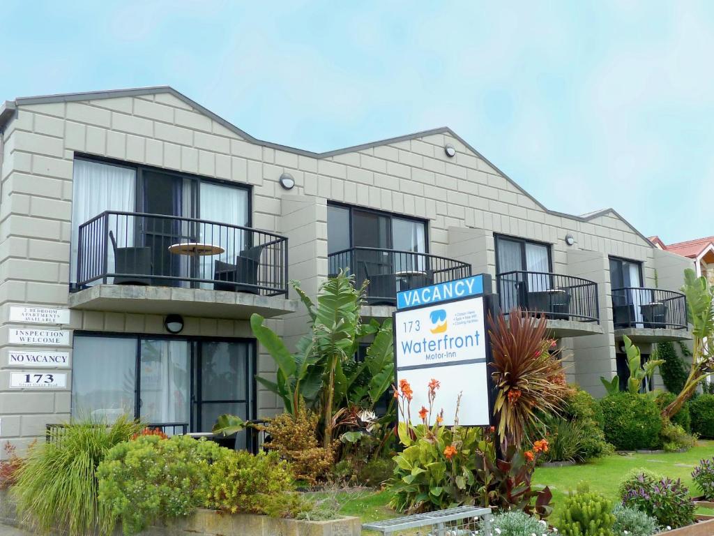 a building with a sign in front of it at Apollo Bay Waterfront Motor Inn in Apollo Bay