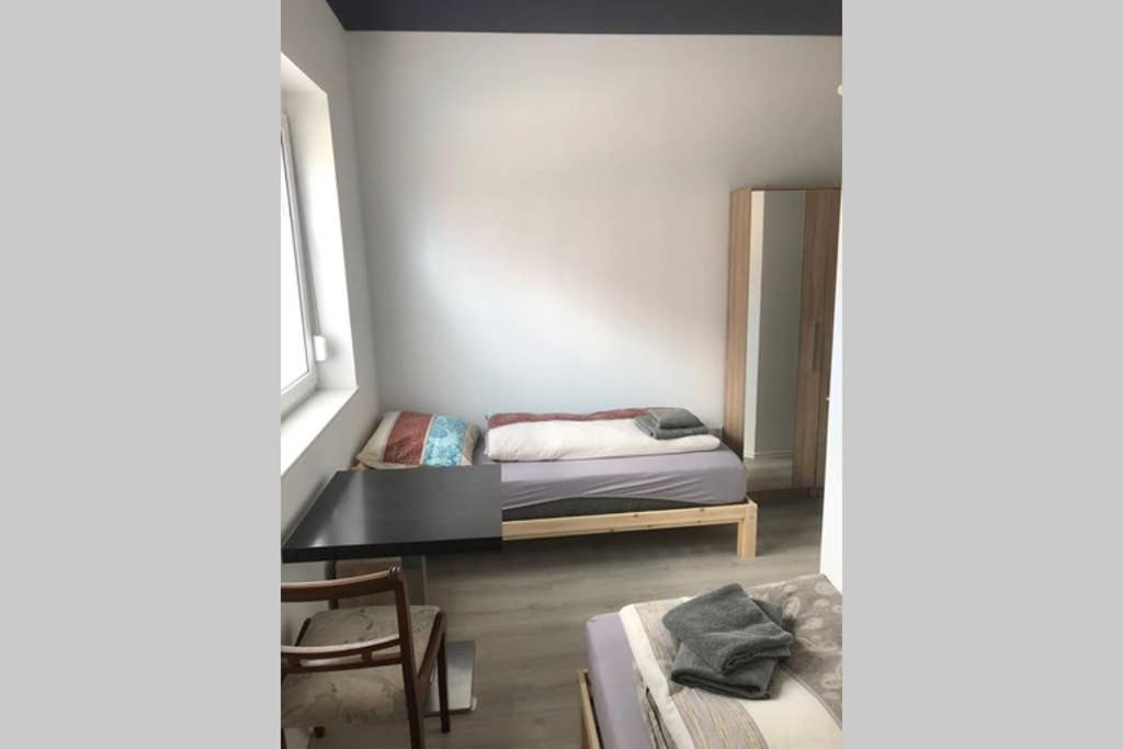 a small bedroom with a bed and a window at Zimmer 2 in Alzenau in Unterfranken