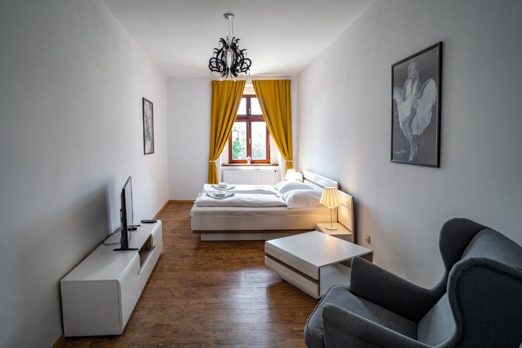 a living room with a couch and a bed at Apartmany Pisek in Písek