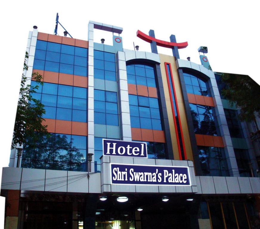 a hotel sign in front of a building at Hotel Shri Swarna's Palace - A Business Class Hotel in Tiruchchirāppalli