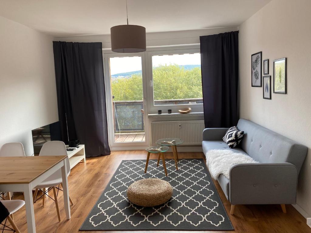 a living room with a couch and a table at FeWo Oberwiesenthal in Kurort Oberwiesenthal