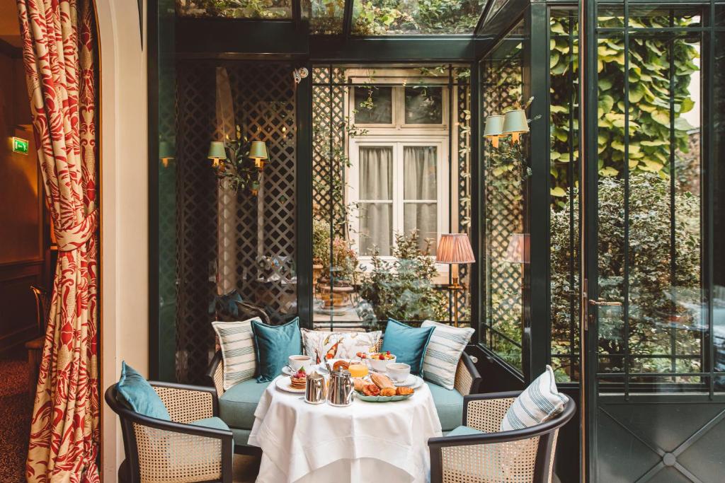 a table with food on top of it on a patio at Hôtel de l&#39;Abbaye in Paris