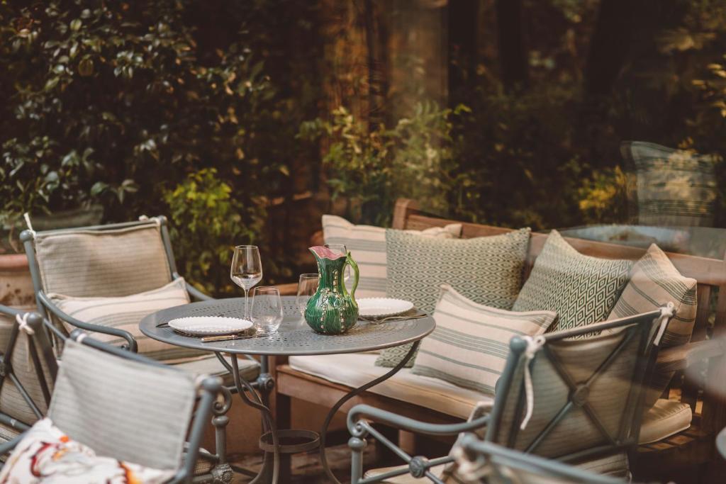 a table and chairs with wine glasses on a patio at Hôtel de l&#39;Abbaye in Paris