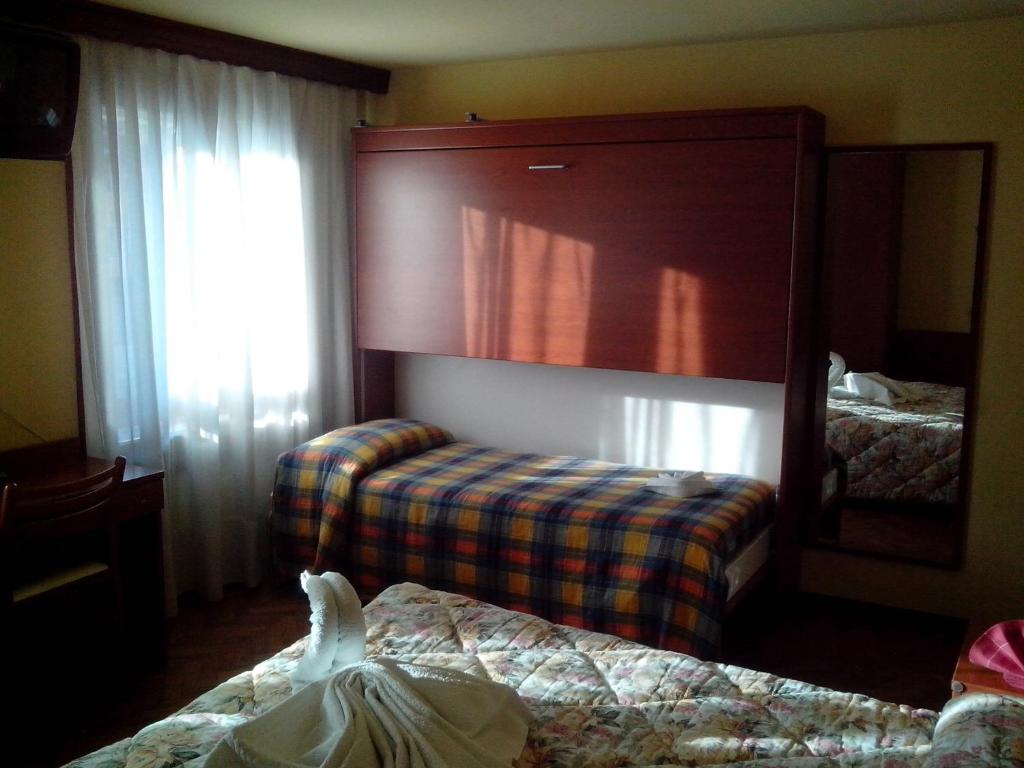 Postel nebo postele na pokoji v ubytování Hotel Monte Fior