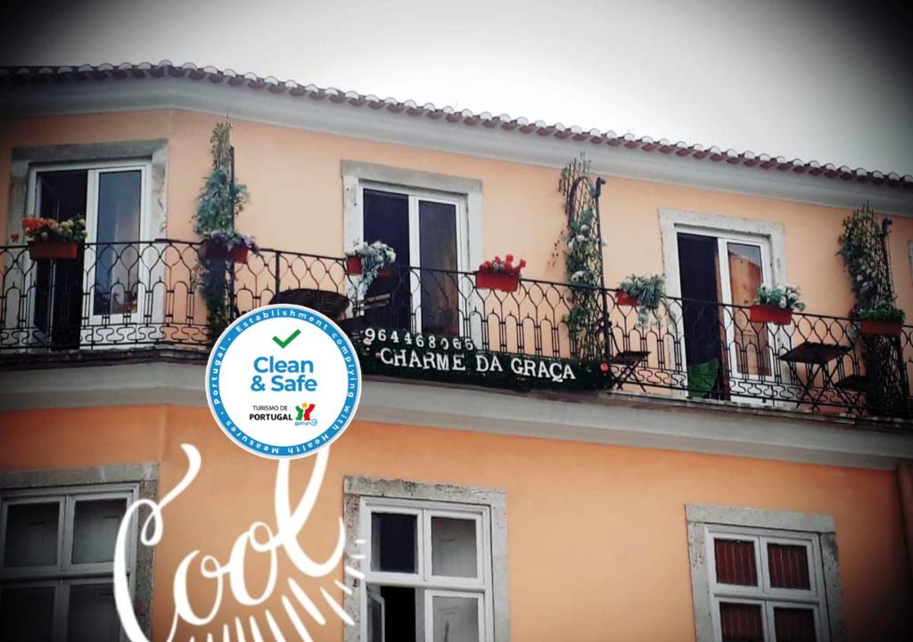 a building with a balcony and a sign on it at Charme da Graça in Lisbon