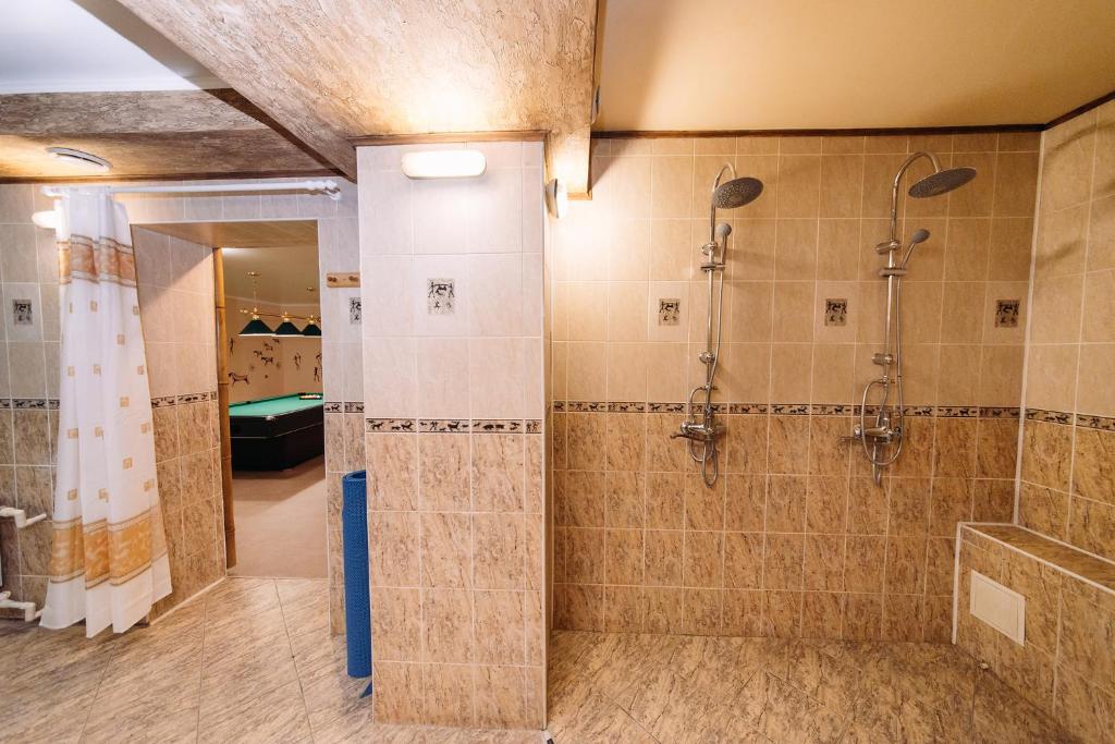 a bathroom with a shower and a walk in shower at Svoyak Hotel in Ufa