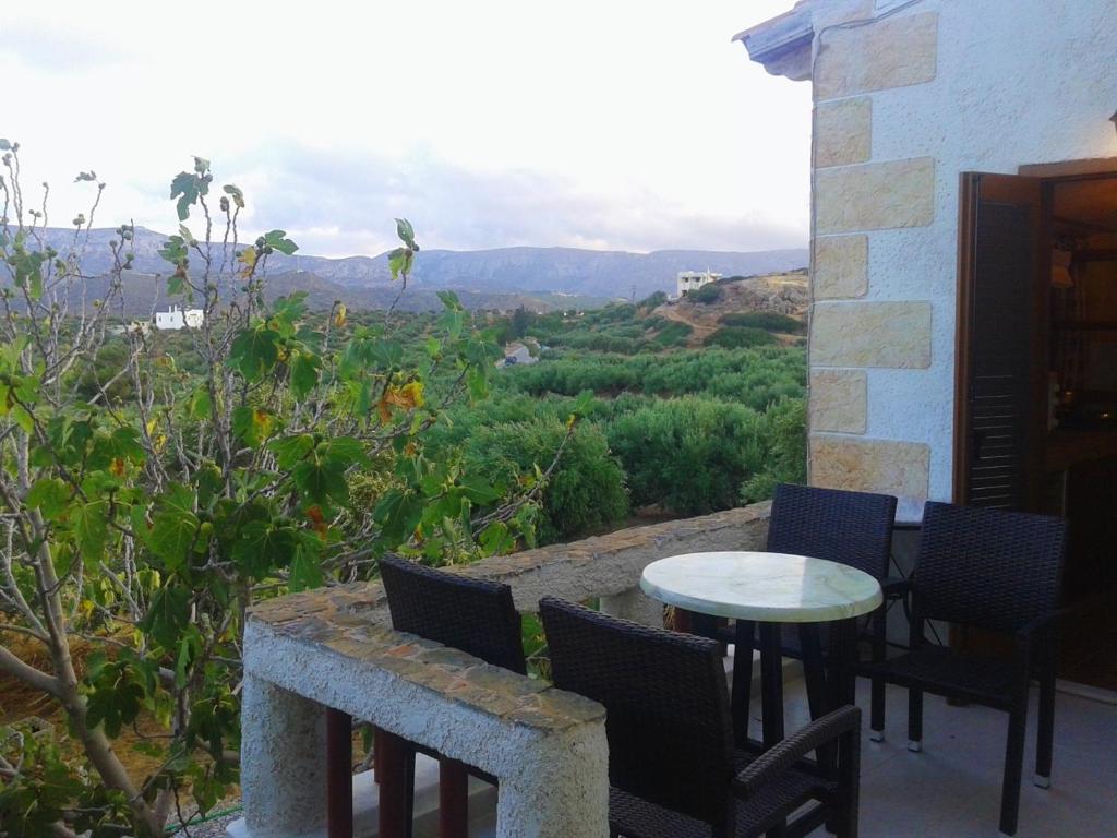 a patio with chairs and a table and a view at Sunrise Apartments in Palekastron