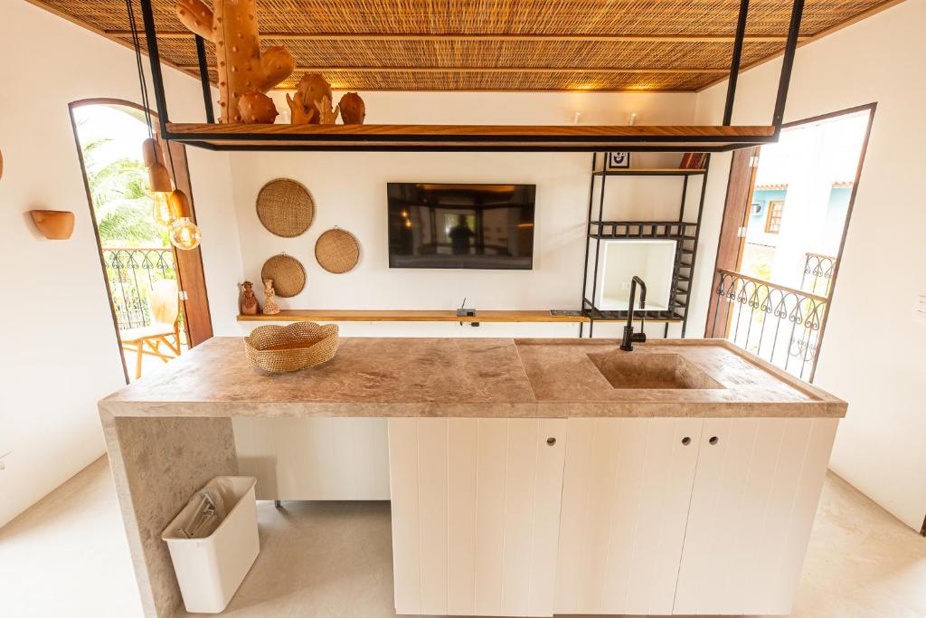 a kitchen with a sink and a mirror at Villa Canziani & Donato in Pôrto de Pedras