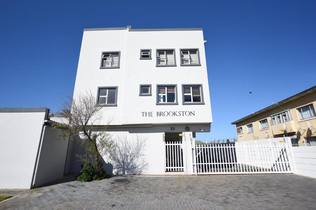un edificio blanco con un letrero que lee el repositorio en The Brookston, en Ciudad del Cabo