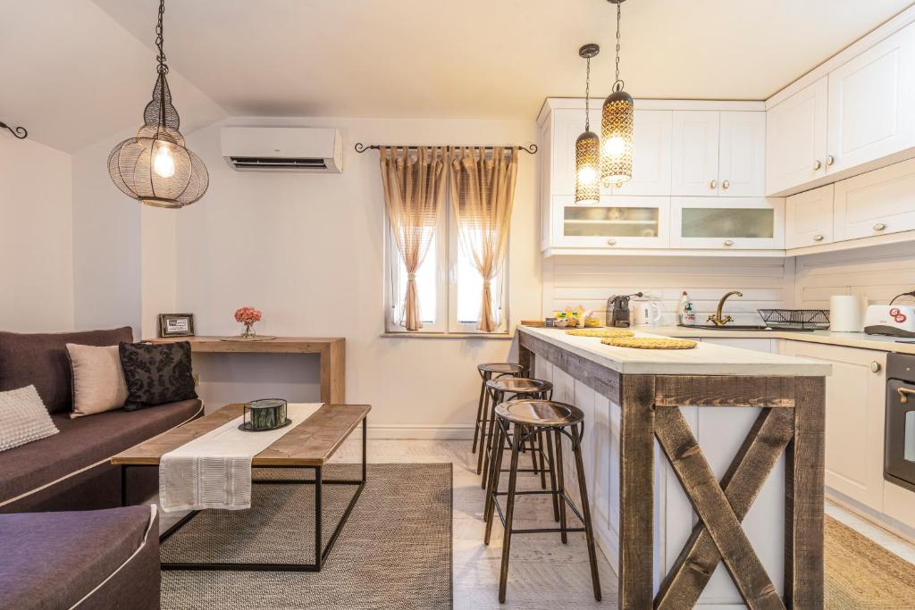 a kitchen and living room with a couch and a table at Stylish 1BD Flat with a terrace near the centre of Plovdiv in Plovdiv