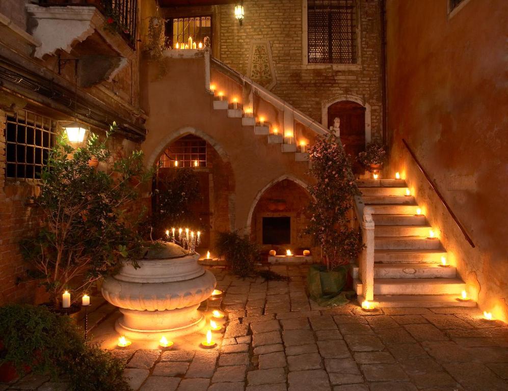 een binnenplaats met een trap en een fontein met verlichting bij Palazzo Odoni in Venetië