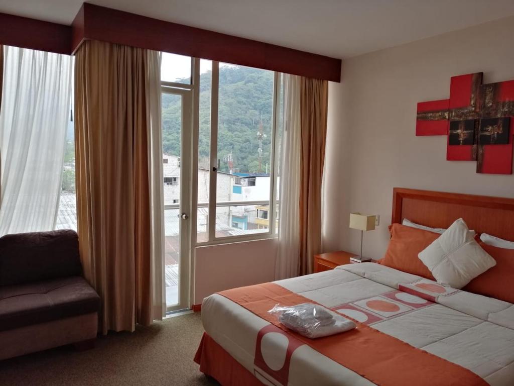 ZamoraにあるHotel Samuriaのベッドと大きな窓が備わるホテルルームです。