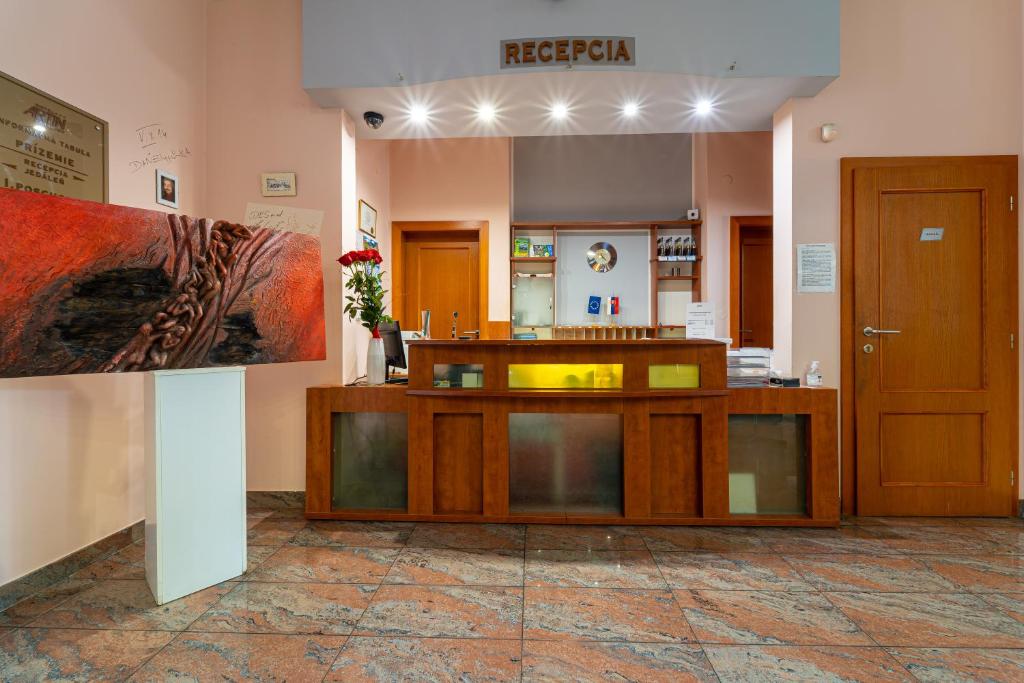 a lobby with a reception desk in a room at Hotel Artin in Bardejov